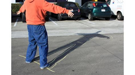 Amputee tracing phantom limb shadows on walls